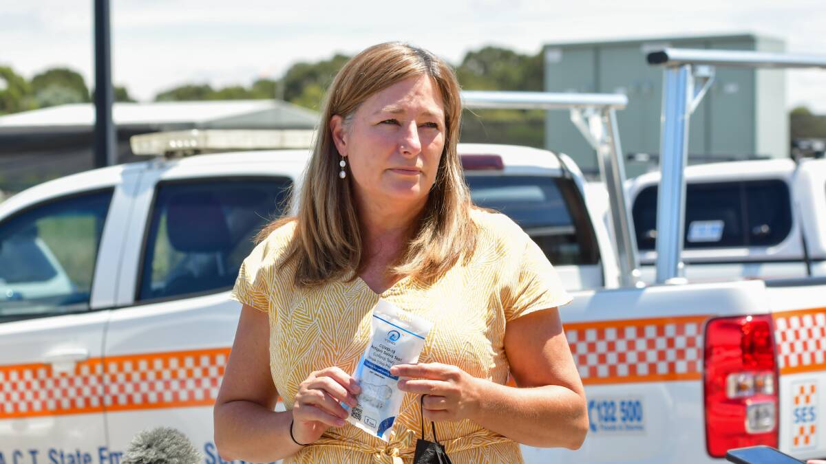 Education Minister Yvette Berry with a rapid antigen test kit as the SES unpacked tests to send out to schools. The tests will now be sent home with students instead of given to parents. Picture: Elesa Kurtz