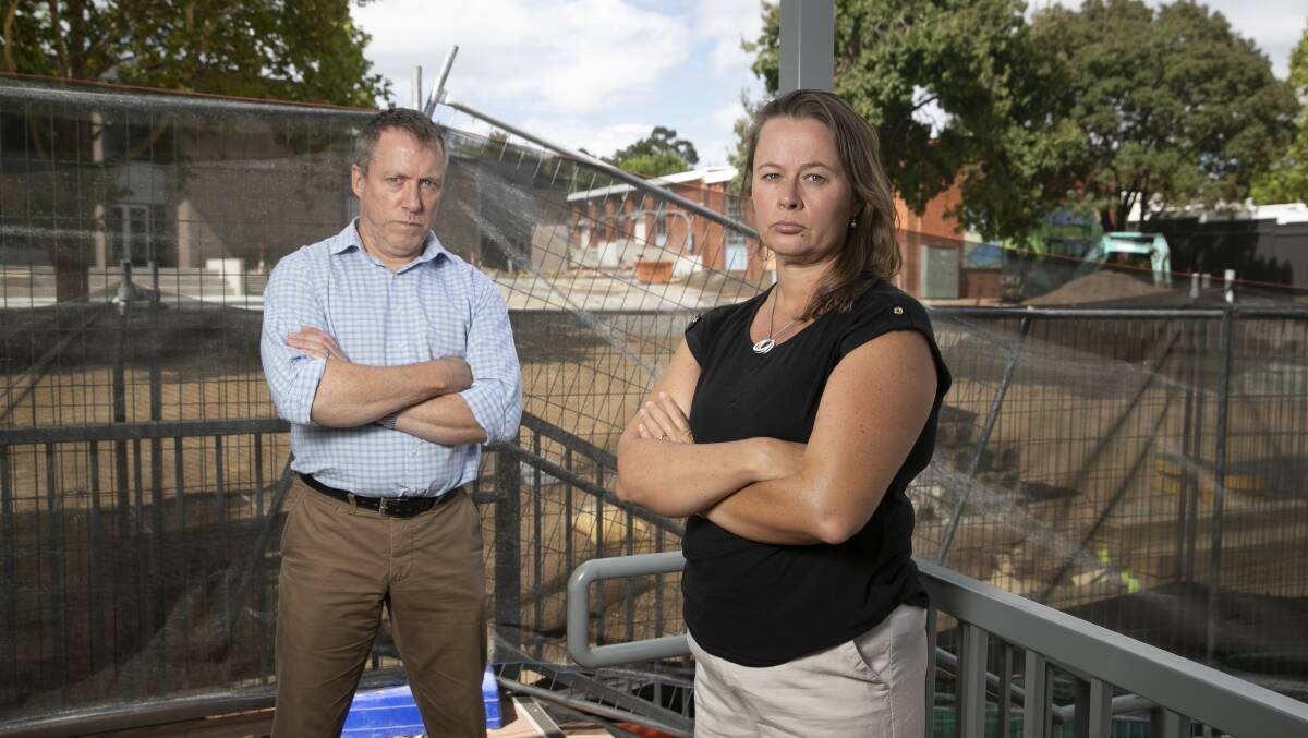 Simon Troeth and Carina Kemp have children attending Campbell Primary School where there have been delays to building modernisation work. Picture: Keegan Carroll