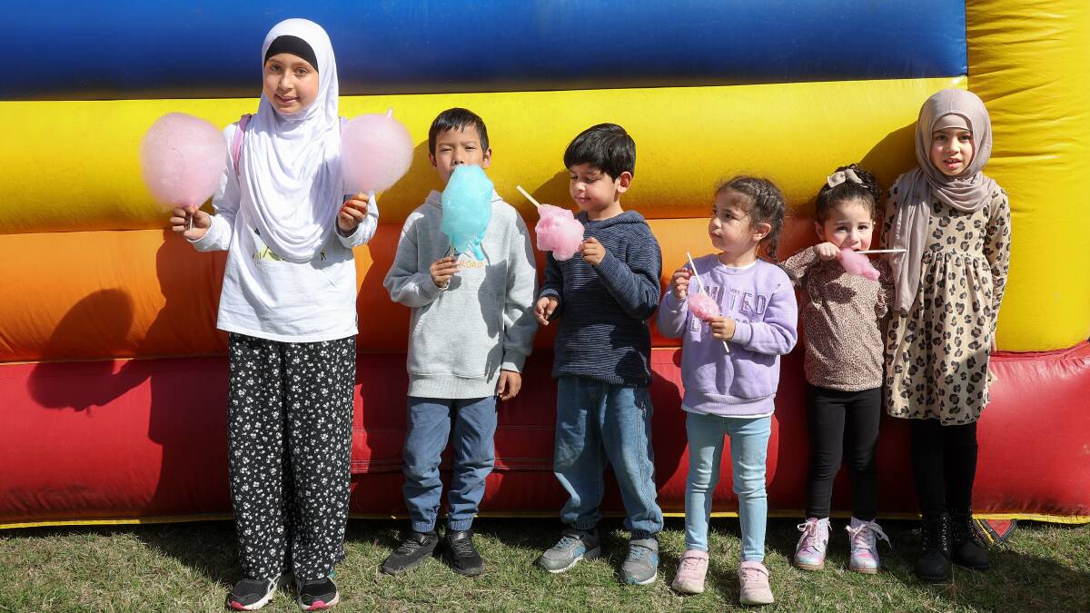 Children tuck into fairy floss at the Canberra Mosque on Sunday. Picture by Sitthixay Ditthavong