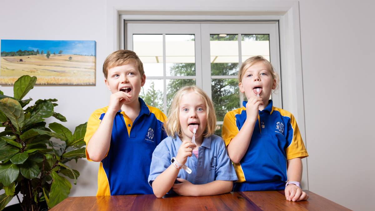 Hugo, 10, Sophie, 8, and Zoe, 6, Kyburz found taking rapid antigen tests to be a novelty in the first week of school. Picture: Sitthixay Ditthavong