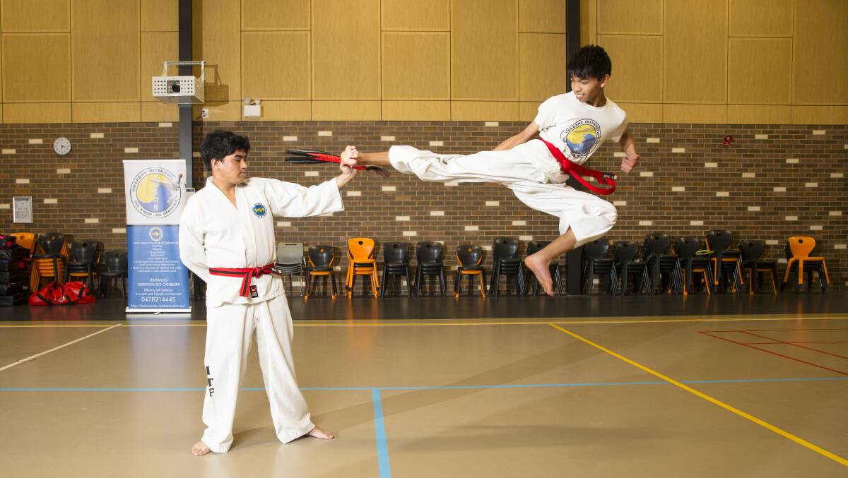 Taekwondo Canberra students Carlos Patriarca and Menard Lopez at training. Picture: Keegan Carroll