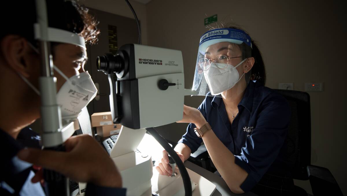 Final year University of Canberra optometry students Emily Tran, right, and Soumil Sharma work on their practical skills. Picture: Sitthixay Ditthavong