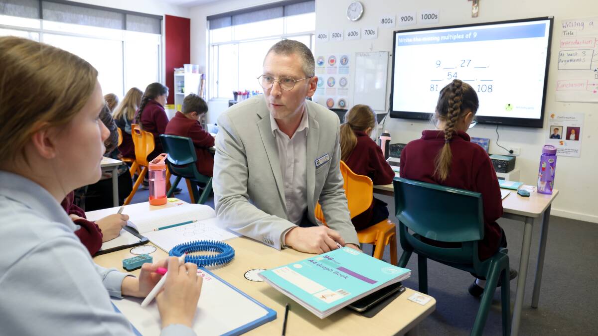 St Thomas Aquinas curriculum coordinator Peter Collins leads a maths review in a year five class. Picture: James Croucher