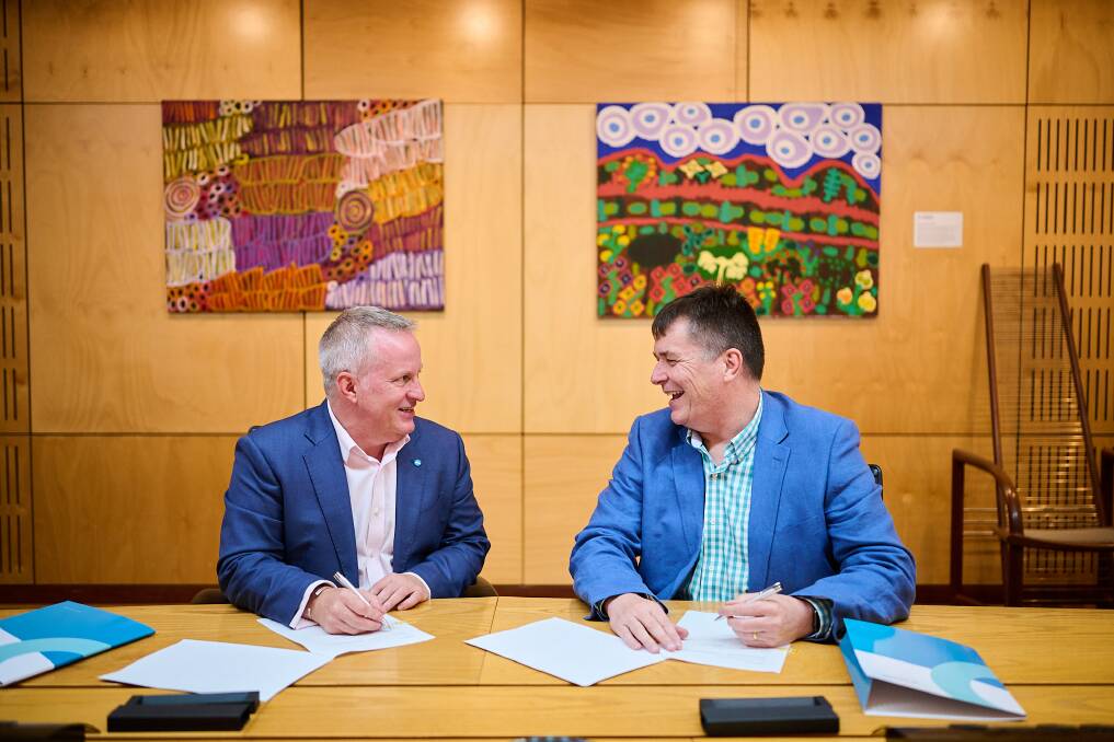 University of Canberra vice-chancellor Paddy Nixon and Instaclustr chief executive officer Peter Lilley sign a memorandum of understanding for a new online software development course. Picture: supplied