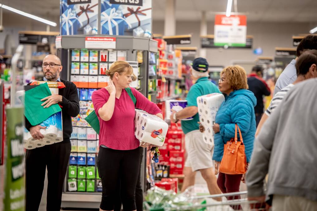 A supermarket worker calls for customers to give staff some space, in line with social distancing guidelines. Picture: Karleen Minney