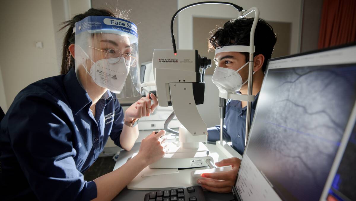 Final year University of Canberra optometry students Emily Tran, left, and Soumil Sharma work on their practical skills. Picture: Sitthixay Ditthavong
