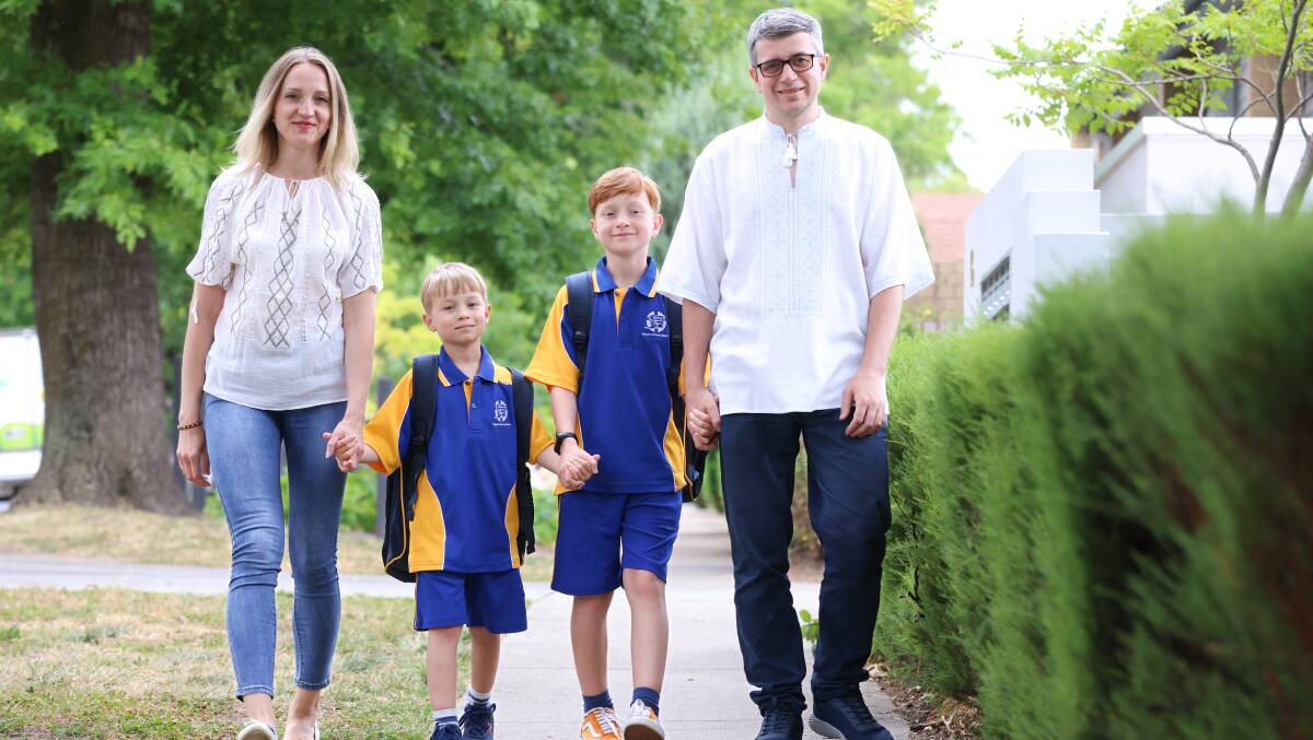 Viktoriia and Volodymyr Cherkach with their sons Oleksandr and Bohdan prepare for their first day at school. Picture by James Croucher