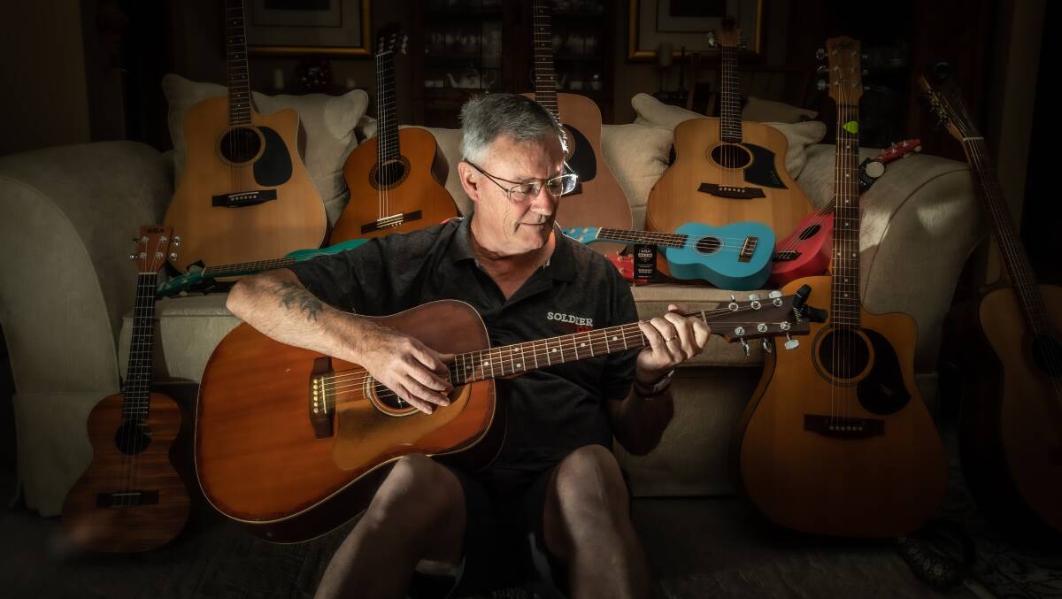 Colin Greef has been collecting donations of guitars and ukuleles for Soldier On. Picture: Karleen Minney