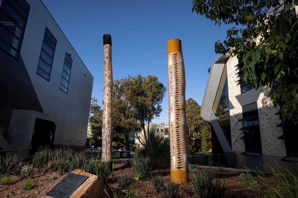 Burial poles from Galiwin'ku installed at the John Curtin School of Medical Research at the Australian National University. Picture: Sitthixay Ditthavong