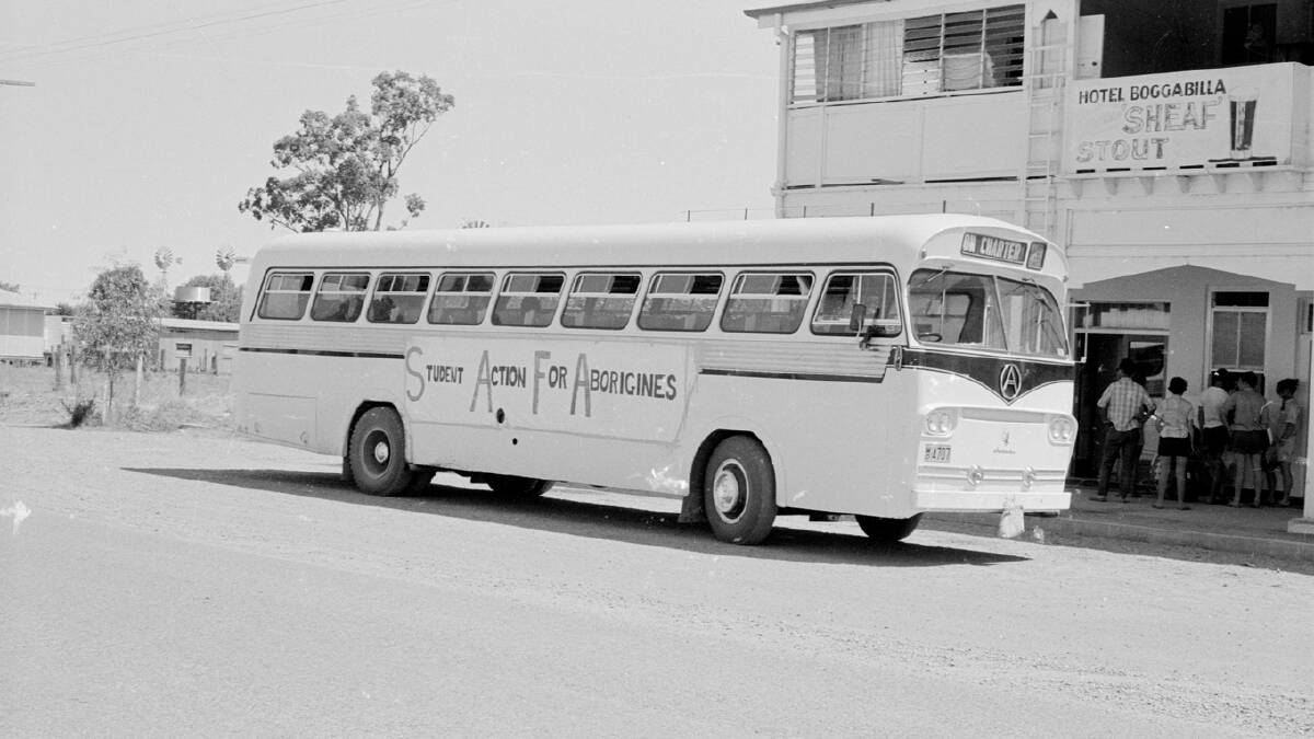 The freedom ride bus outside Hotel Boggabilla in 1965. The students stopped at the hotel before interviewing people at the Aboriginal reserve at Boggabilla. Picture by Mitchell Library, State Library of New South Wales and Courtesy SEARCH Foundation