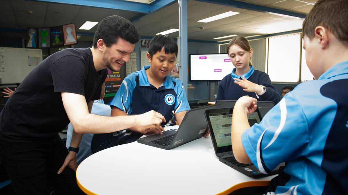 Maribyrnong Primary School year 6 students Aizen Dang, Claire Ackland and Brayden Smith with Day of AI facilitator Zach Wingrave. Picture by Elesa Kurtz