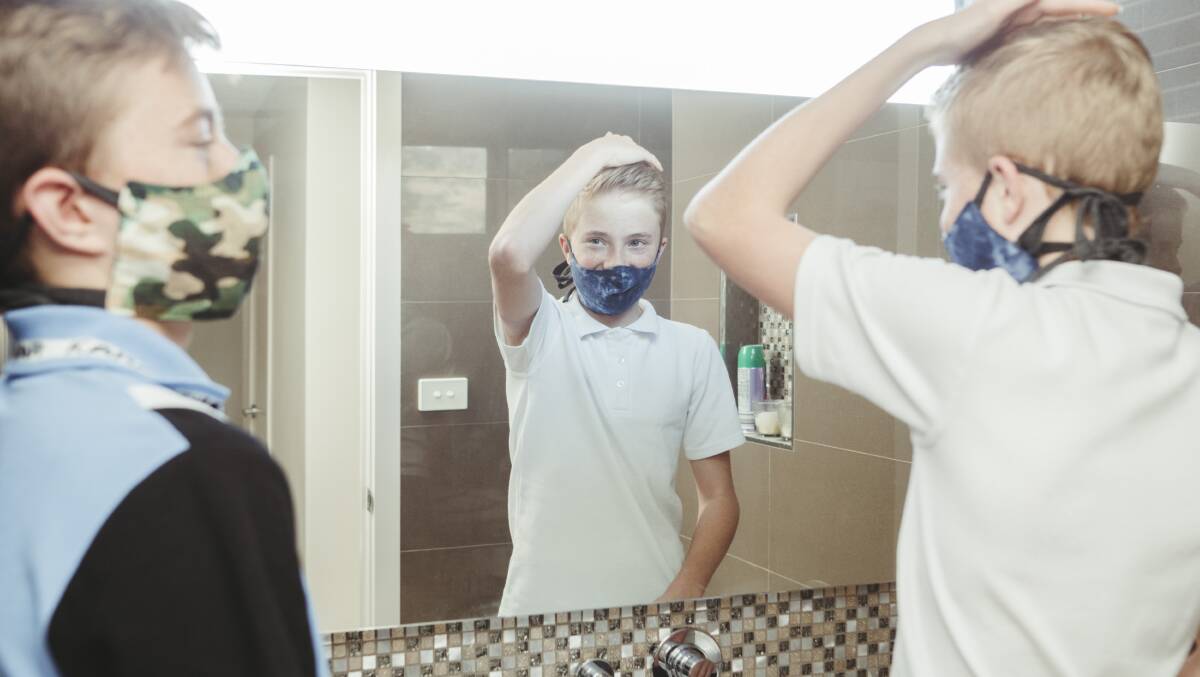 Karabar High School students Bas landman Year 11, and his brother Tim Landman year 9, pictured preparing for school at their home in Jerrabomberra. NSW high school students were encouraged to wear masks in school from term 3. Picture: Dion Georgopoulos