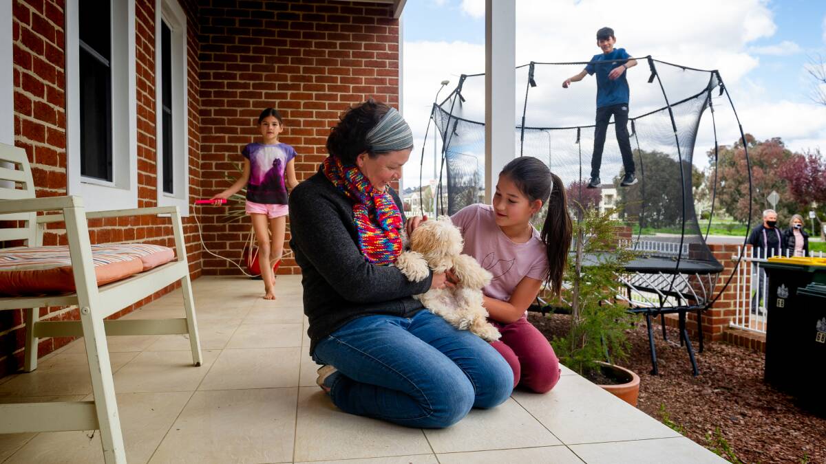 Kerrie Oei and her children Alysha, 8, Madison, 10, and Izaac, 12, have been planning activities for the school holidays in lockdown along with their dog Taffy. Picture: Elesa Kurtz