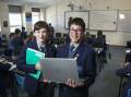 Zac Thewlis and Adam Alexandra Maricic from Marist College Canberra where year 7 and 8 have returned to paper workbooks. Picture: Keegan Carroll