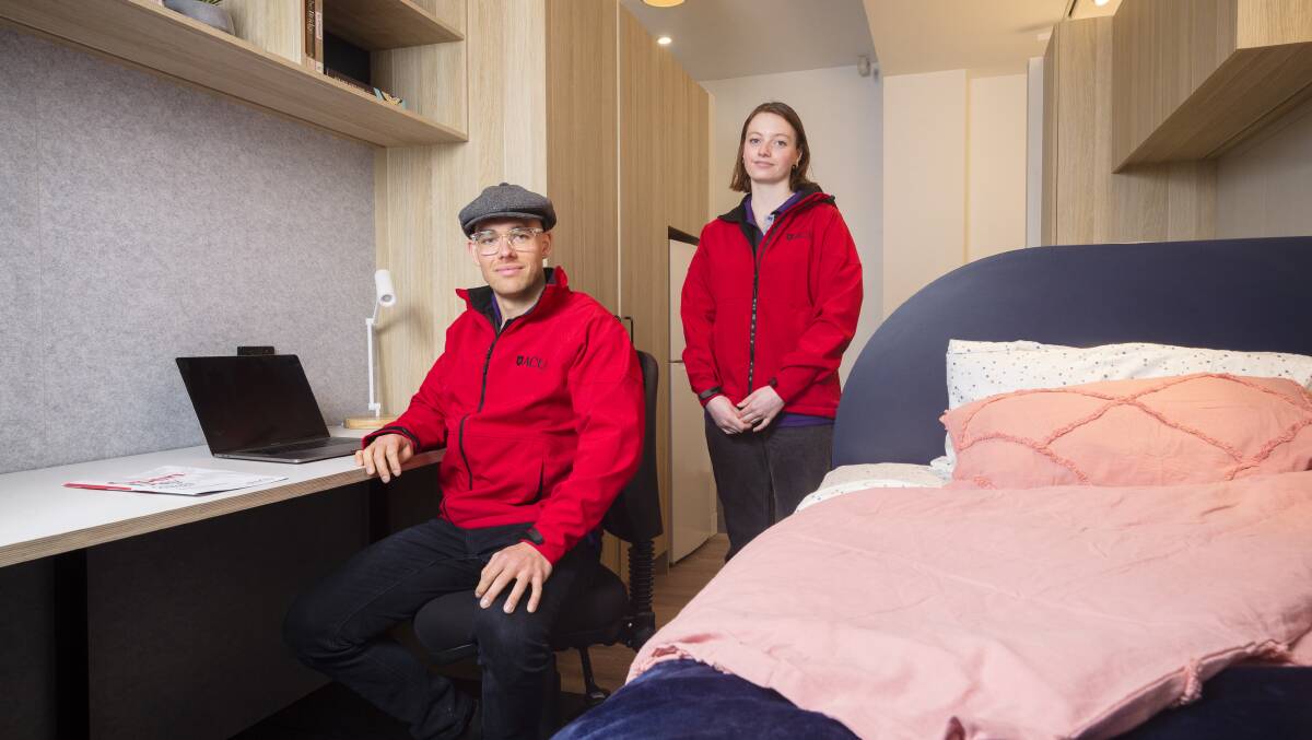 Social work students Cameron Day and Madison Mills in a display model of the planned student accommodation. Picture: Keegan Carroll