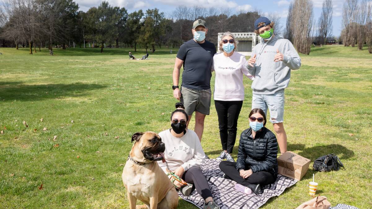 Nicole, Luke, Jo, Jaclyn, and Johnny de Mamiel with Capone the bull mastiff enjoy a picnic in Tuggeranong Town Park. Picture: Sitthixay Ditthavong
