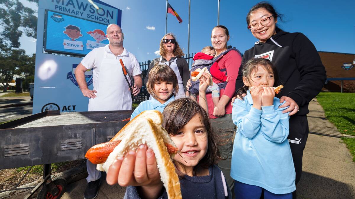 Mawson Primary School P&C committee members Mick Blucher, Jessica Coates, Qi Zhang and Olga Rogacheva with Pepper and Rosie Kaur and Xinran Si. Picture: Sitthixay Ditthavong
