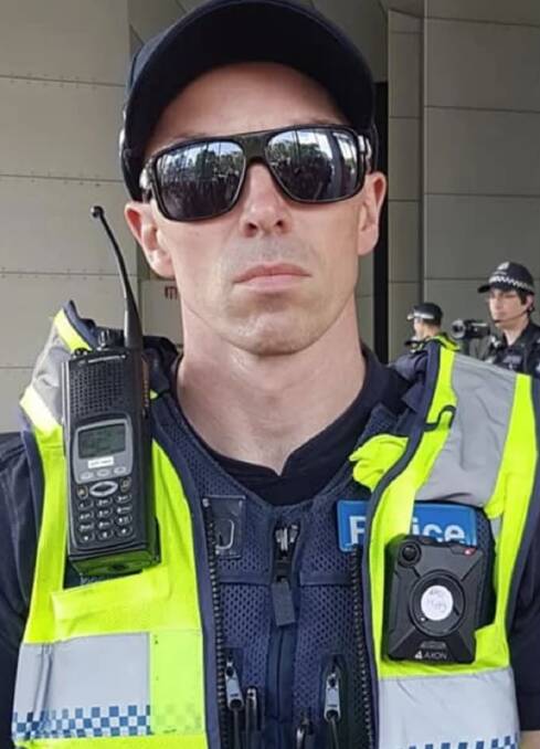 Victoria Police is investigating this officer who wore an 'EAD Hippy' sticker during the protests. Photo: Kate Thomson.
