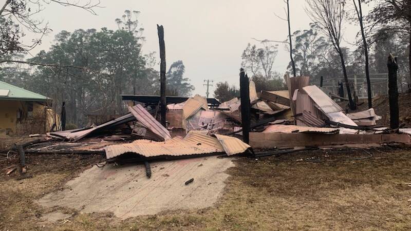 The remains of a tack shed and barn destroyed in Bodalla on Thursday, January 23.
