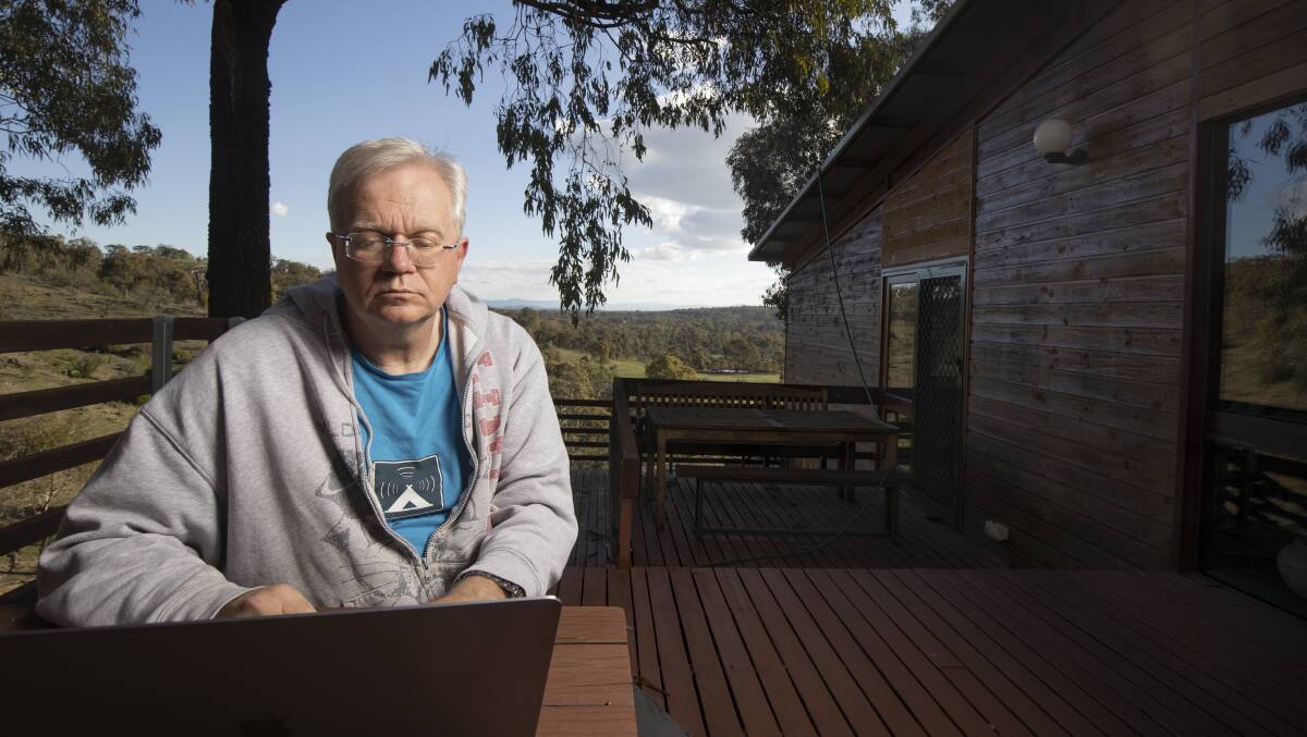 Australian National University vice chancellor Professor Brian Schmidt works from his deck on his property near Sutton. Picture: Sitthixay Ditthavong