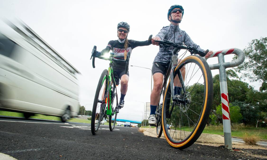 Roslyn Harper, left, and Leonie Doyle negotiate the crossing over a slip lane on Adelaide Avenue, a required manoeuvre which they say hampers commuter cycling. Picture: Karleen Minney