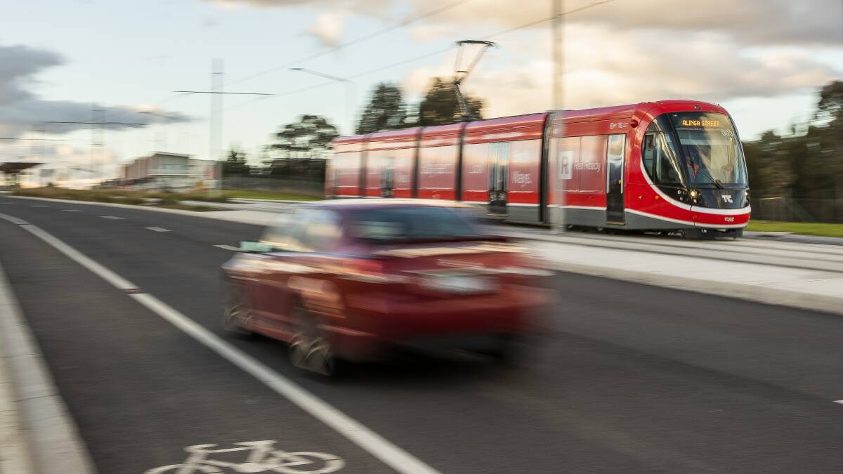 A south-bound light rail service heads along Flemington Road to the city. Picture by Sitthixay Ditthavong