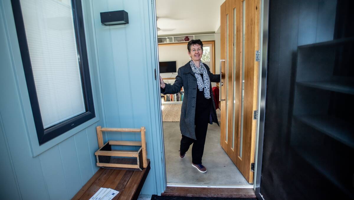 Julie Hamilton at the front door of her Torrens house on Monday, built in the backyard of her former residence. Picture by Karleen Minney
