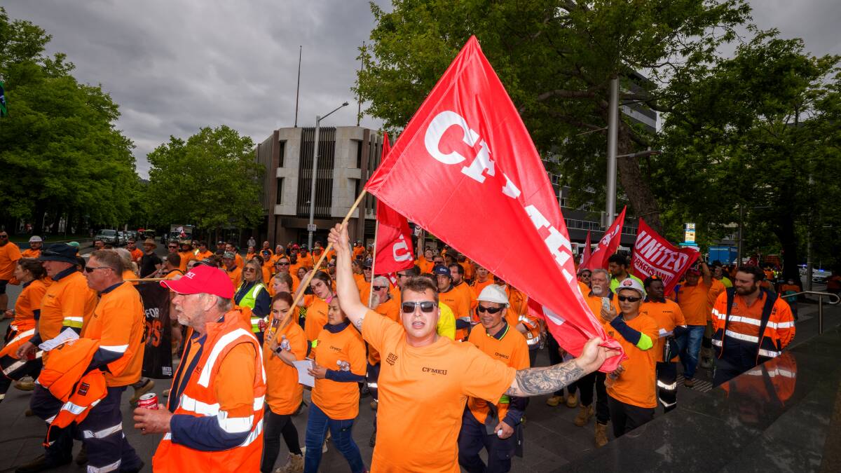 Union members marched on Civic Square on Thursday, calling for pay rises and reclassification of low-paid government workers. Picture by Sitthixay Ditthavong