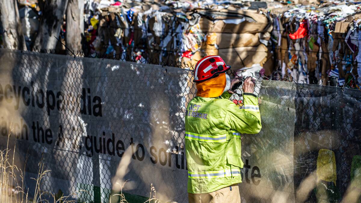 A firefighter inspects compacted recycling at the destroyed Hume processing facility on December 27, 2022. Picture by Karleen Minney