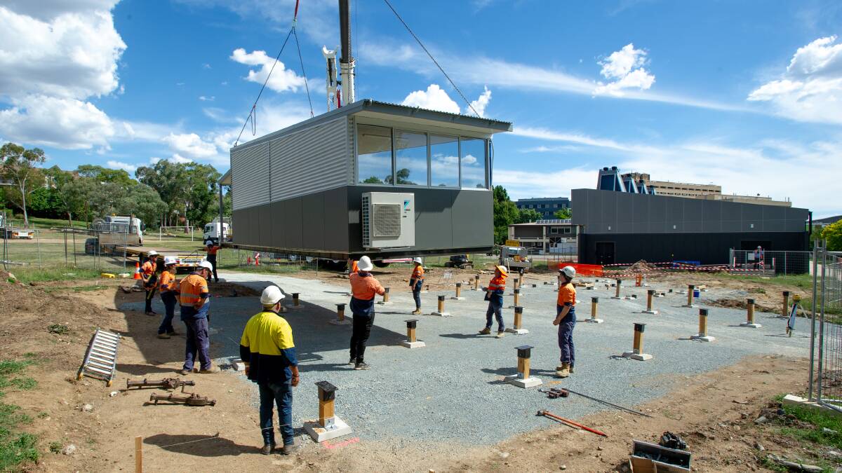 A transportable classroom is lowered into position at Garran Primary School in time for the start of the 2021 school year. Picture: Elesa Kurtz