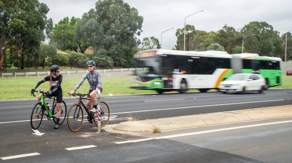 Commuting cyclists Roslyn Harper, left, and Leonie Doyle cycle along Adelaide Avenue during the morning peak hour. Picture: Karleen Minney