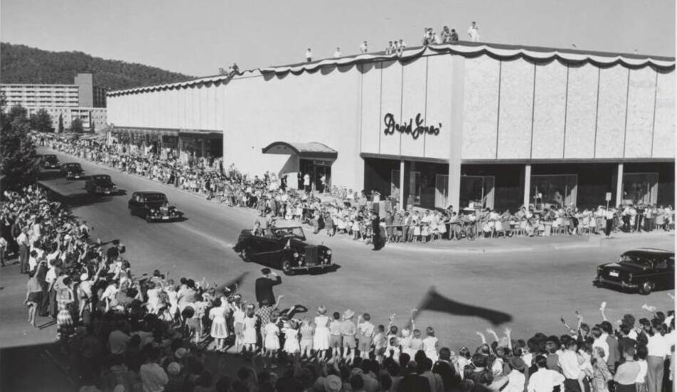 Crowds line the streets around David Jones in Canberra's city centre in 1963 to see Queen Elizabeth II and the Duke of Edinburgh drive by. Picture National Library