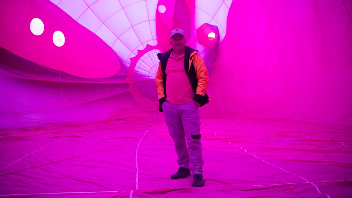 Balloon pilot Craig Farrell stands inside Allycorn during its inflation on Saturday. Picture: Keegan Carroll 
