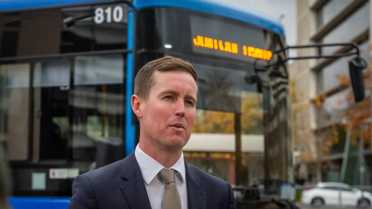Transport Minister Chris Steel in front of a battery electric bus from the Transport Canberra fleet. Picture by Karleen Minney