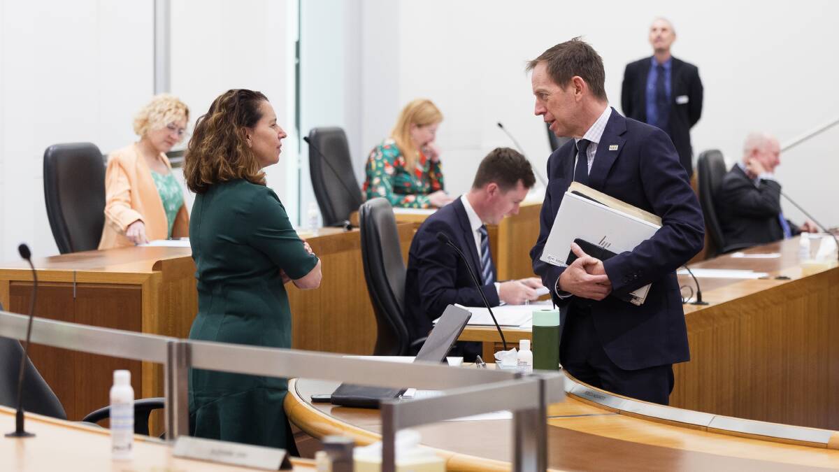 ACT Greens leader Shane Rattenbury, right, talks with Greens cabinet minister Rebecca Vassarotti in the Legislative Assembly in November 2022. Picture by Sitthixay Ditthavong
