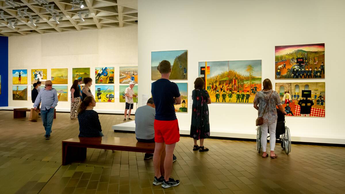 Visitors to the National Gallery on Friday take in Sidney Nolan's Ned Kelly series, painted between 1946-7. Picture by Elesa Kurtz