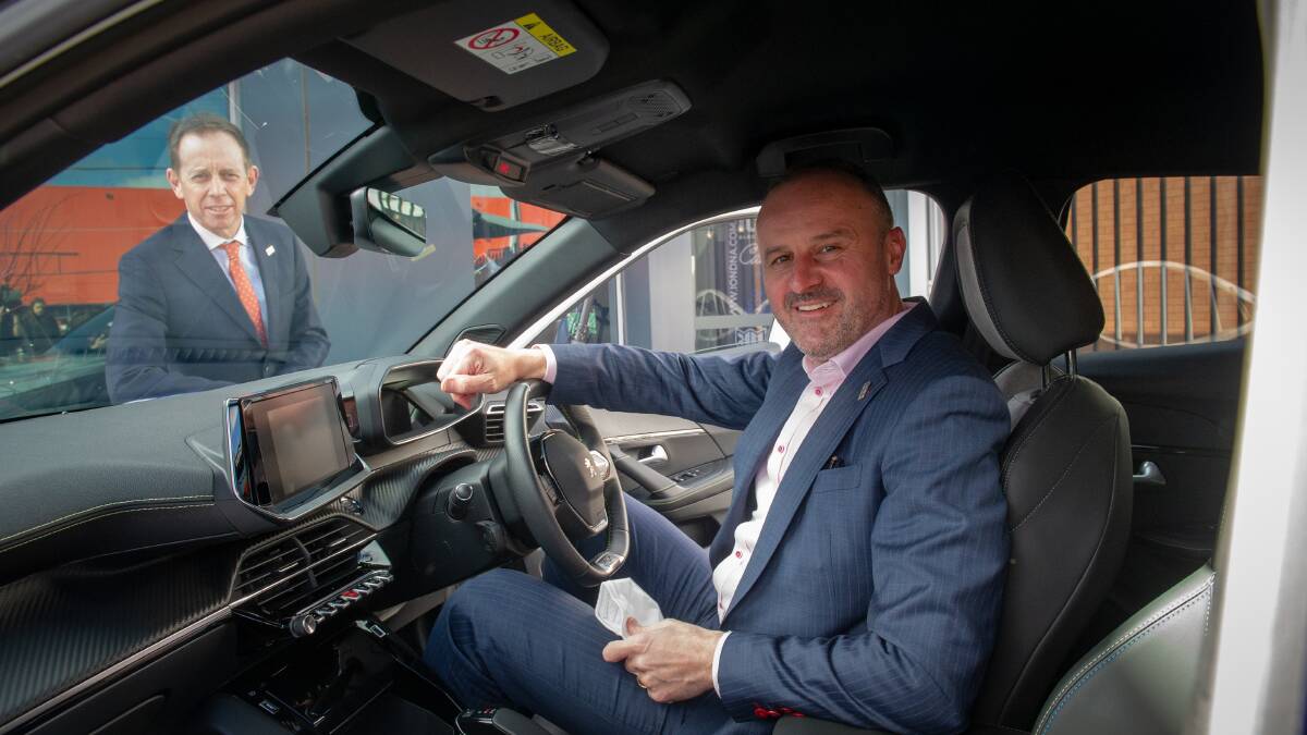 Chief Minister Andrew Barr, in the driver's seat, and Greens leader Shane Rattenbury at an announcement of the government's electric vehicle strategy in July. Picture by Elesa Kurtz