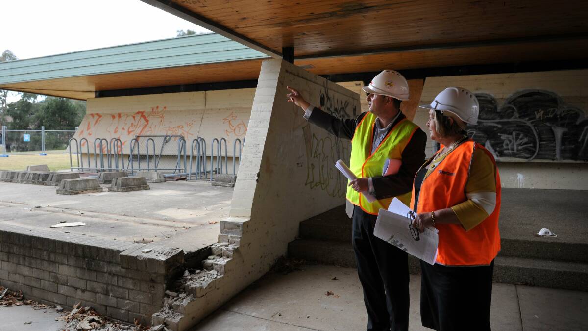 Site project manager Franco Frino shows ACT Minister for Community Services Joy Burch what is planned for the community hub at the former Flynn primary school in 2011. Picture: Elesa Kurtz