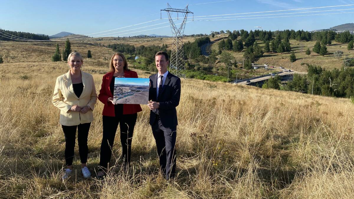 Federal Infrastructure Minister Catherine King, centre, with Labor MLA Marisa Paterson, left, and ACT Transport Minister Chris Steel with Coppins Crossing in the background. Picture by Jasper Lindell