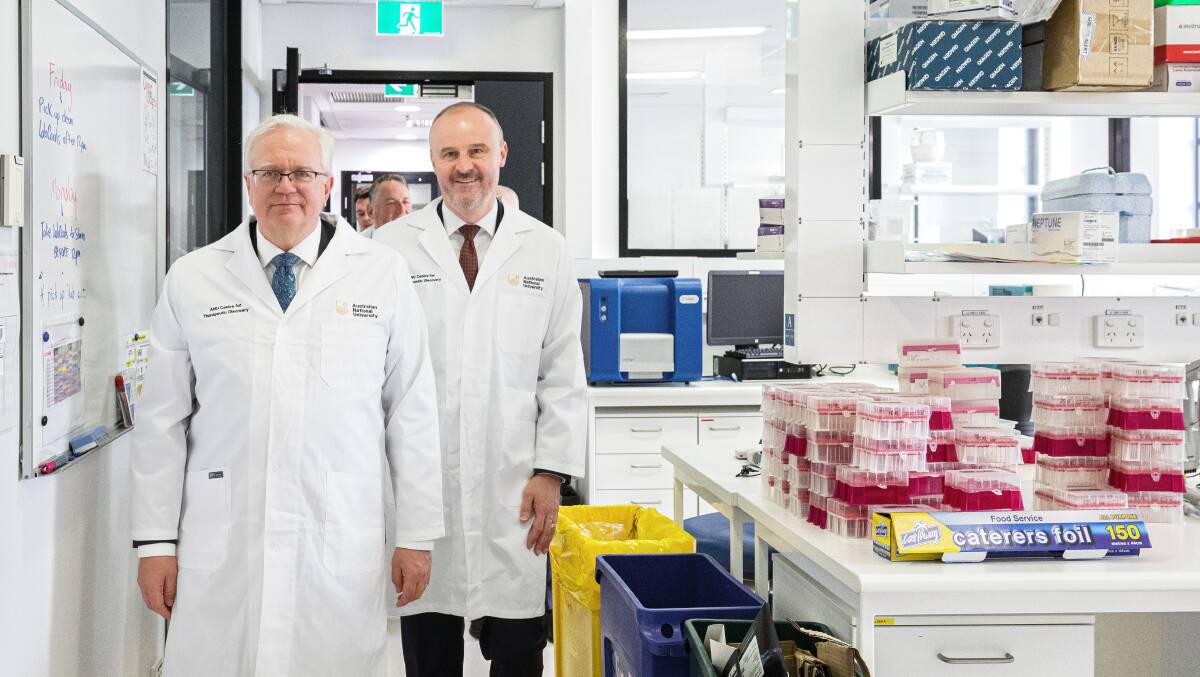 ANU vice-chancellor Brian Schmidt, left, and ACT Chief Minister Andrew Barr in a lab at the John Curtin School of Medical Research on Thursday, where they announced a new health precinct for the university. Picture by Sitthixay Ditthavong