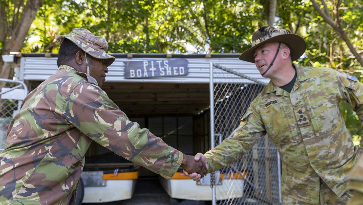 Papua New Guinea soldier Corporal Harris Duncan, from the 2nd Battalion, Royal Pacific Islands Regiment assault pioneers, greets Commander of 3rd Brigade, Brigadier Scott Winter, AM, at 'Pit's Boat Shed' during Exercise Wantok Warrior in Wewak, Papua New Guinea. Picture: Department of Defence