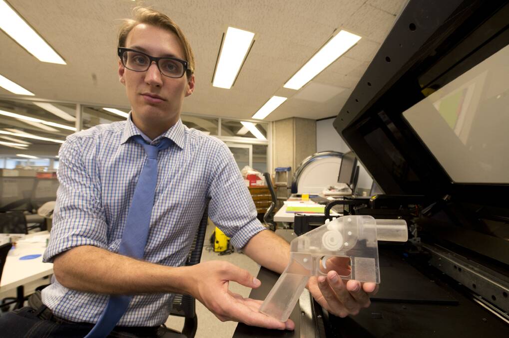 A Canadian researcher holds a gun made by a 3D printer several years ago. It was to stop it shooting bullets, but raised concerns. Pictures: Getty Images