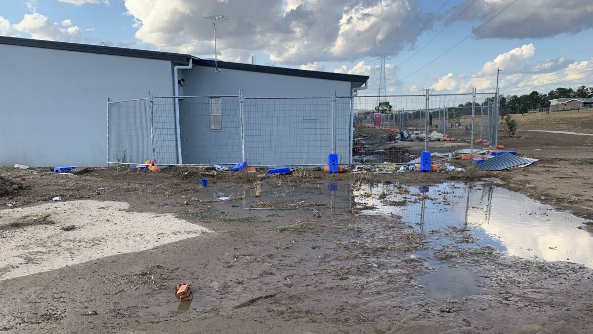 Flooding at Ginninderra Estate after rain in January 2020. Residents say their garages and backyards have flooded on multiple occasions.