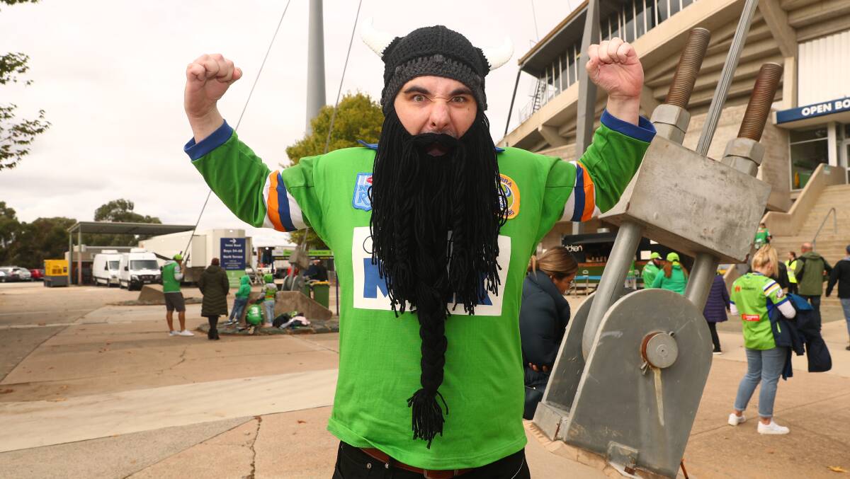 Raiders fan Alessandro Oliveira joins other Green Machine supporters at the team's season opener against Wests Tigers. Picture: Keegan Carroll