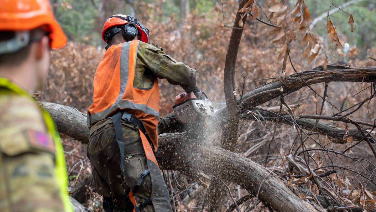 Military personnel clear a horse trail while assisting bushfire responses last summer. Picture: Department of Defence