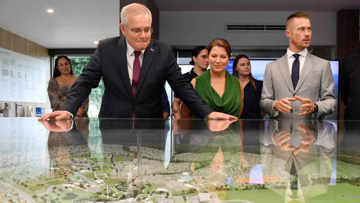 Prime Minister Scott Morrison, wife Jenny and Liberal candidate for Blair Sam Biggins at Springfield Rise Display Village. Picture: AAP