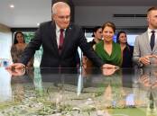 Prime Minister Scott Morrison, wife Jenny and Liberal candidate for Blair Sam Biggins at Springfield Rise Display Village. Picture: AAP