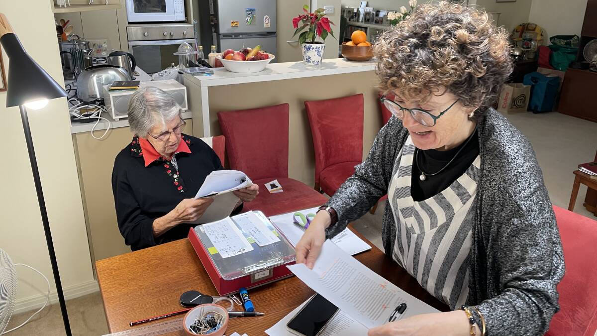 Joan Montgomery and Kim Rubenstein, checking details in the manuscript of 'The Vetting of Wisdom'. Picture: Supplied