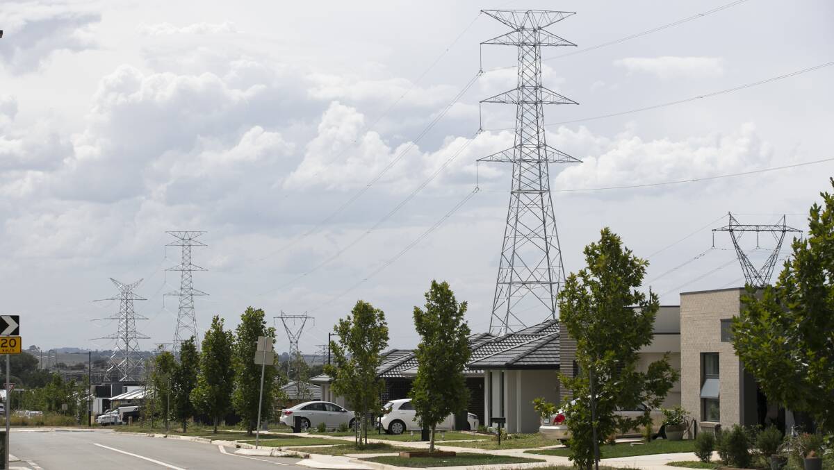 Electricity towers and lines next to new homes on Lionel Rose Street in Ginninderra Estate, Holt. Picture: Keegan Carroll