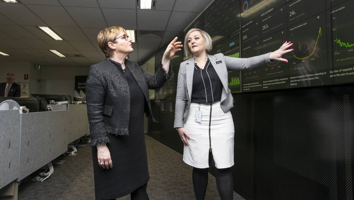 Services Australia official Kelly Taylor shows Government Services Minister Linda Reynolds the technology at its operations centre. Picture: Keegan Carroll